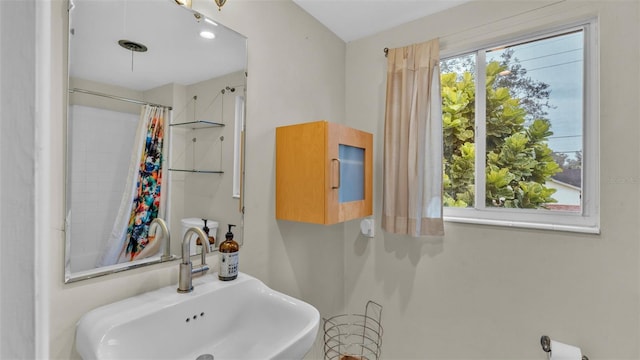 bathroom featuring curtained shower and sink