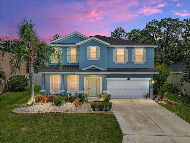 view of front facade featuring a garage and a lawn