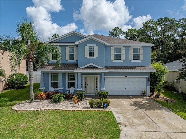 view of front of house with a garage and a front lawn