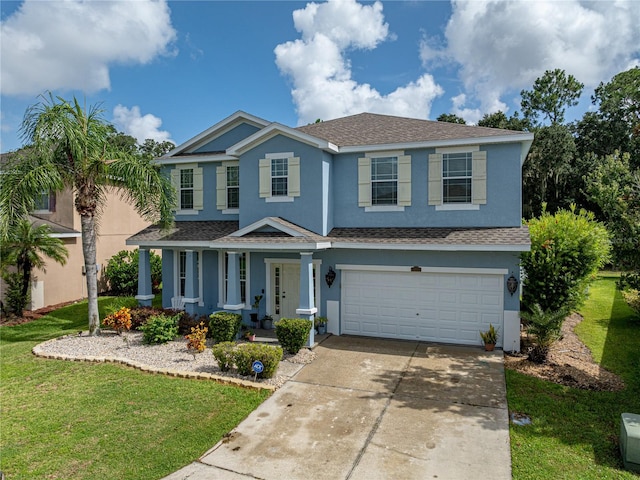 view of front of property with a garage and a front lawn