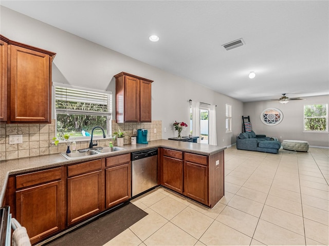 kitchen featuring light tile patterned floors, kitchen peninsula, dishwasher, backsplash, and ceiling fan