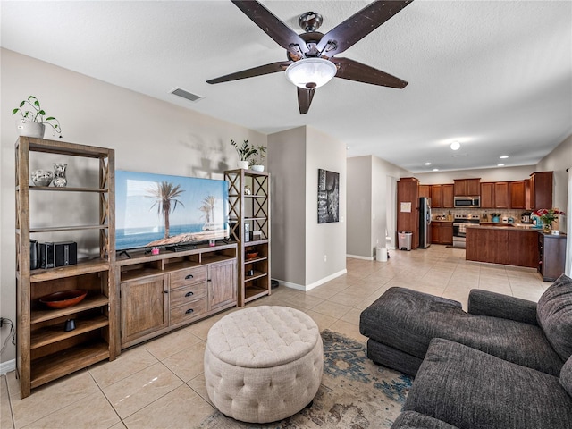 living room featuring ceiling fan and light tile patterned floors