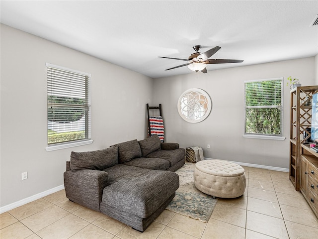 living room featuring light tile patterned floors, a healthy amount of sunlight, and ceiling fan