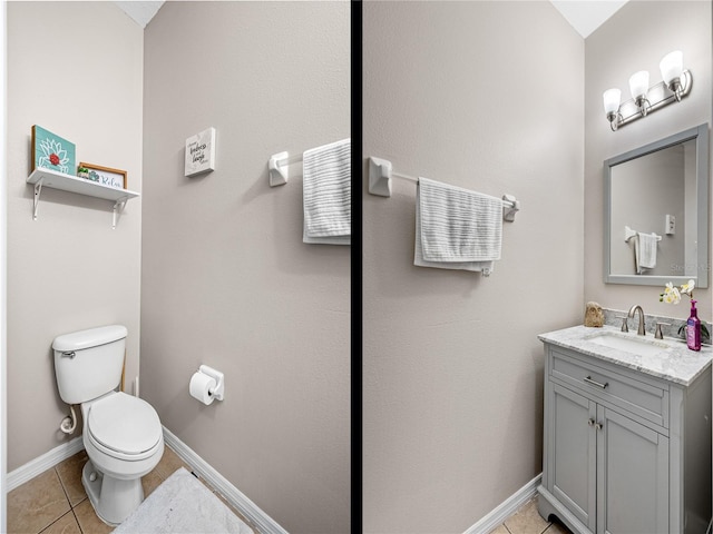 bathroom with vanity, toilet, and tile patterned floors