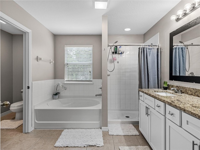 full bathroom with independent shower and bath, vanity, tile patterned floors, and toilet