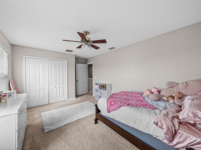 carpeted bedroom featuring a closet and ceiling fan