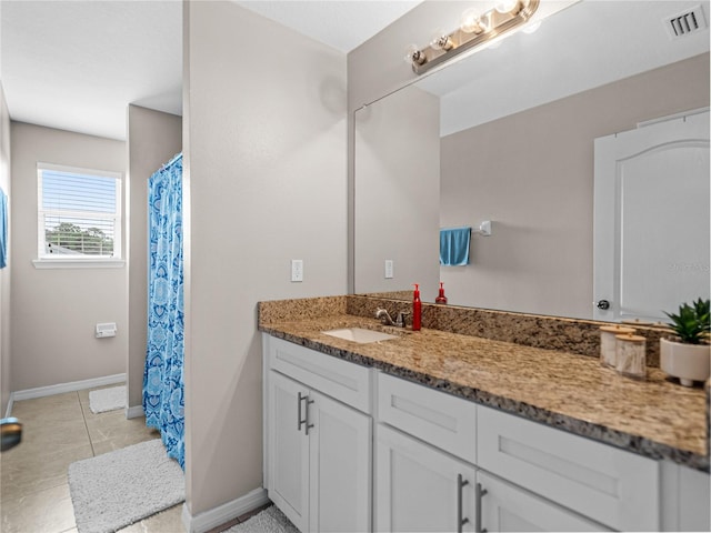 bathroom with tile patterned flooring and vanity