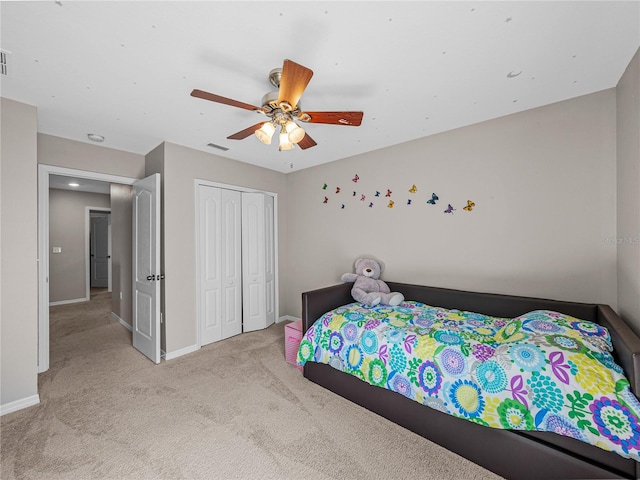 bedroom featuring light carpet, a closet, and ceiling fan