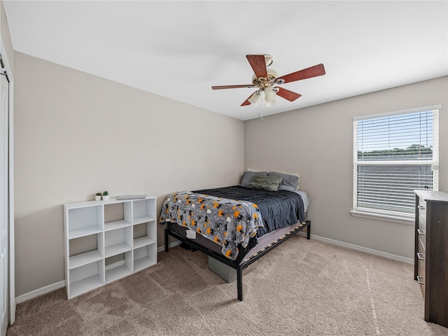 bedroom with light colored carpet and ceiling fan