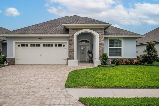 view of front facade with a garage and a front yard