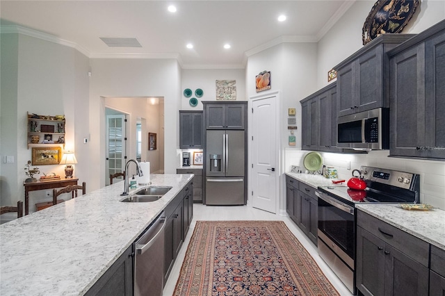 kitchen with tasteful backsplash, sink, stainless steel appliances, crown molding, and light stone countertops