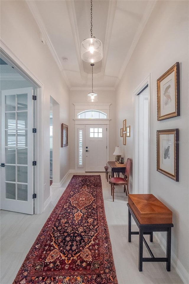 foyer featuring crown molding