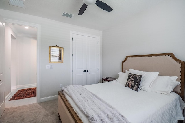 carpeted bedroom with a closet and ceiling fan