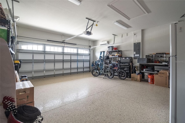 garage featuring a garage door opener, electric panel, and white fridge