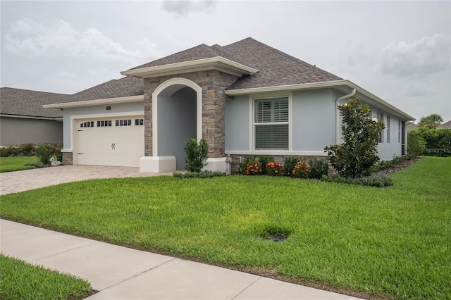 view of front of property with a garage and a front lawn