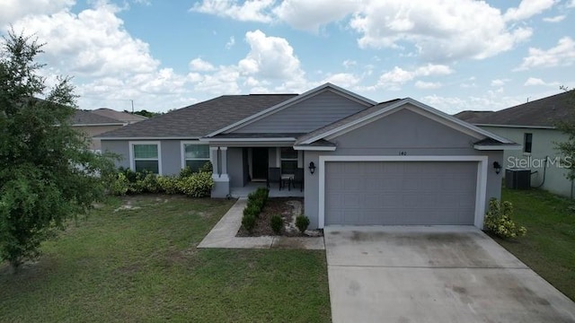 single story home with a garage, central AC, and a front yard