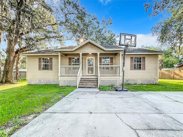 ranch-style home with a porch and a front lawn