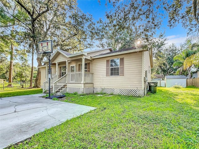 view of front of home with covered porch and a front yard