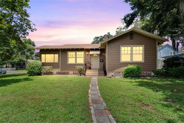 view of front of home featuring a lawn