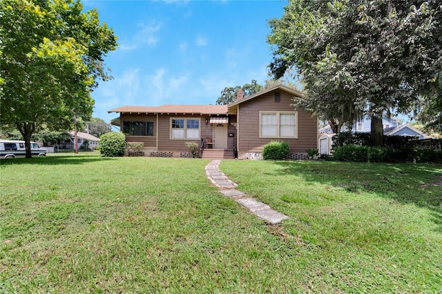 single story home featuring a front lawn