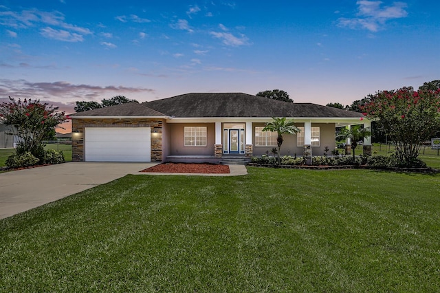 view of front of house featuring a yard, a porch, and a garage