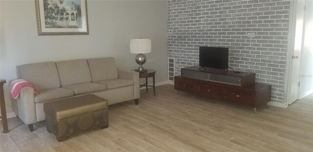 living room featuring a fireplace and light hardwood / wood-style flooring