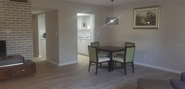 dining space with sink and hardwood / wood-style floors