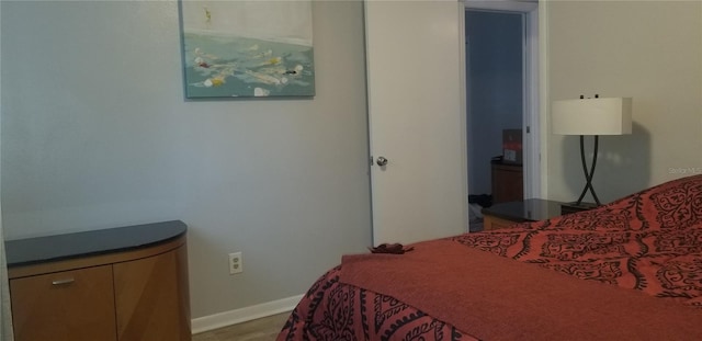 bedroom with hardwood / wood-style flooring