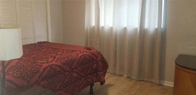 bedroom featuring a closet and light wood-type flooring