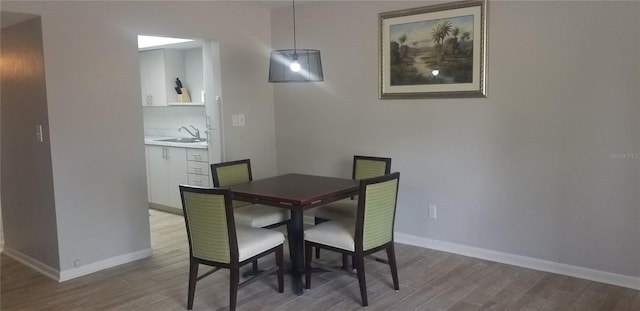 dining area featuring hardwood / wood-style floors and sink