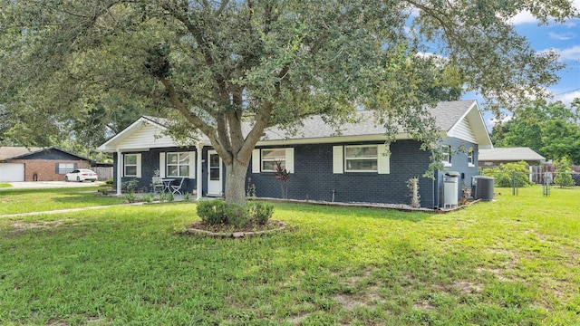 ranch-style home featuring a front yard and central AC