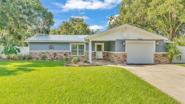 ranch-style home featuring a garage and a front lawn