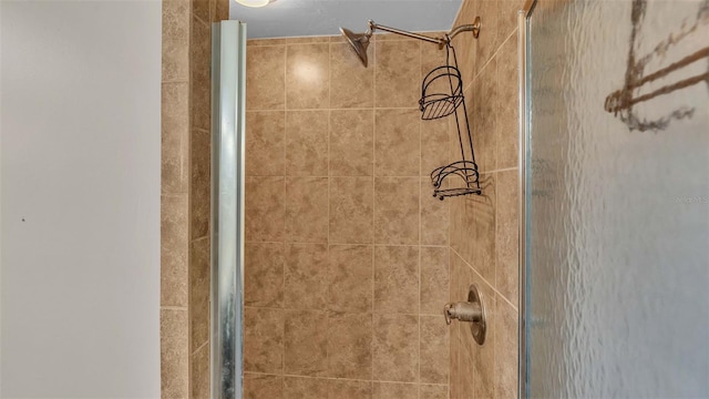 bathroom with a shower with shower door