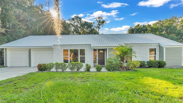 ranch-style home with a front yard and a garage