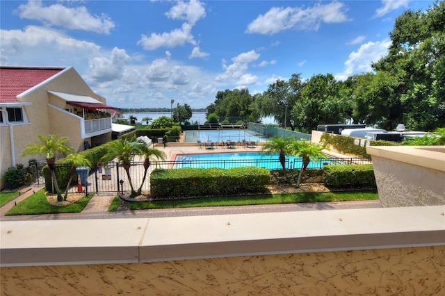 view of home's community with a water view, a patio area, fence, and a pool