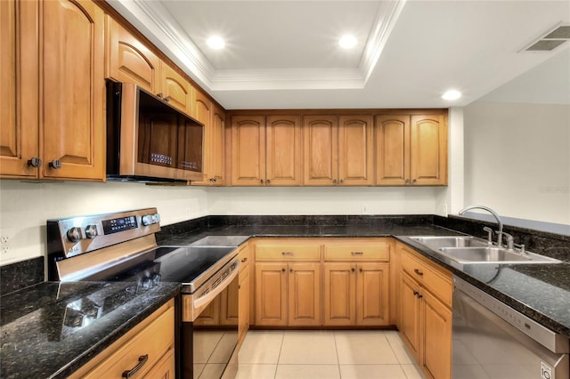 kitchen featuring crown molding, appliances with stainless steel finishes, a raised ceiling, and a sink