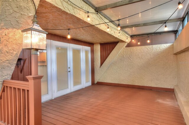 basement featuring french doors and hardwood / wood-style floors