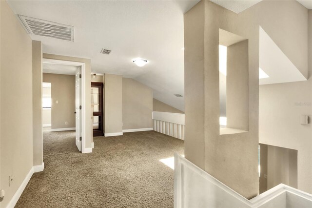 additional living space featuring lofted ceiling and carpet