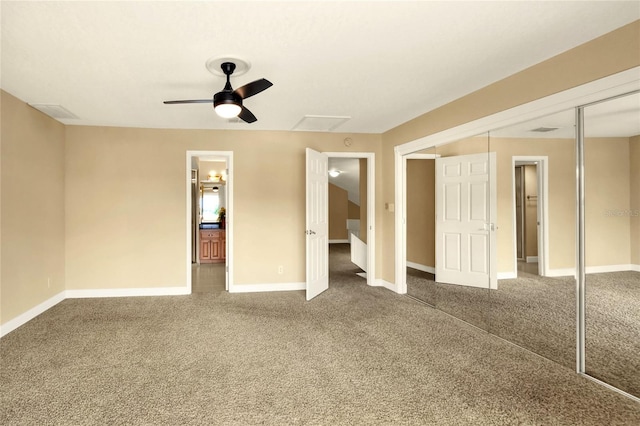 unfurnished bedroom with ensuite bathroom, ceiling fan, carpet flooring, and a closet