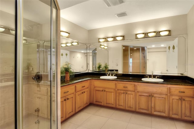 bathroom featuring a sink, visible vents, and a shower stall