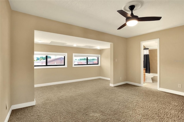 empty room featuring carpet, baseboards, and ceiling fan