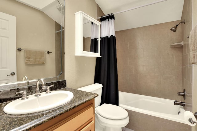 full bathroom featuring tiled shower / bath combo, toilet, and vanity