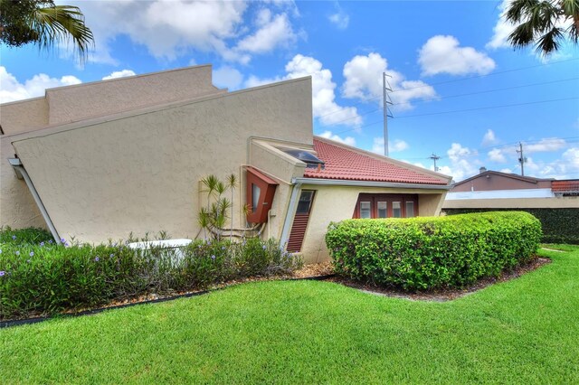 view of side of home featuring a lawn