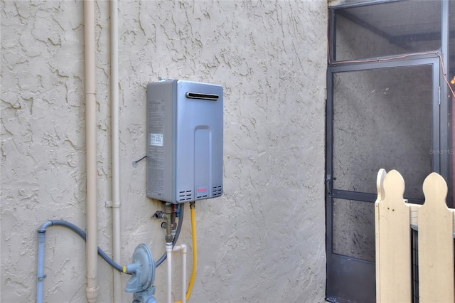 exterior details with tankless water heater and stucco siding