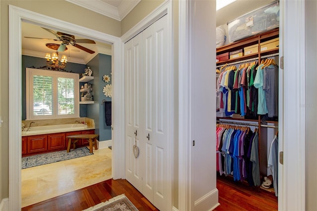 interior space with dark hardwood / wood-style flooring, an inviting chandelier, and ornamental molding