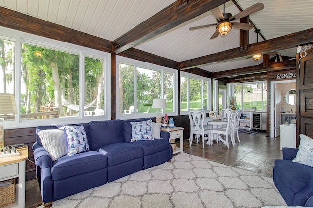 sunroom featuring a wealth of natural light, ceiling fan, and lofted ceiling with beams