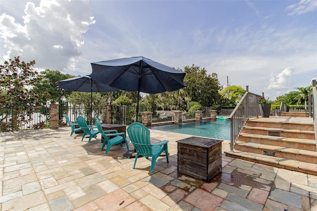 view of swimming pool featuring pool water feature and a patio area