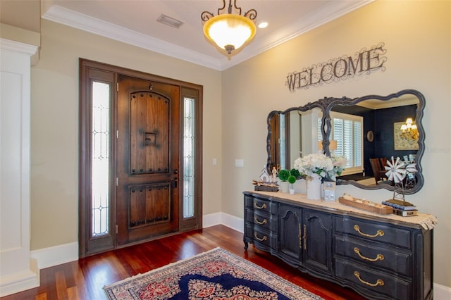 entryway with dark hardwood / wood-style floors and ornamental molding