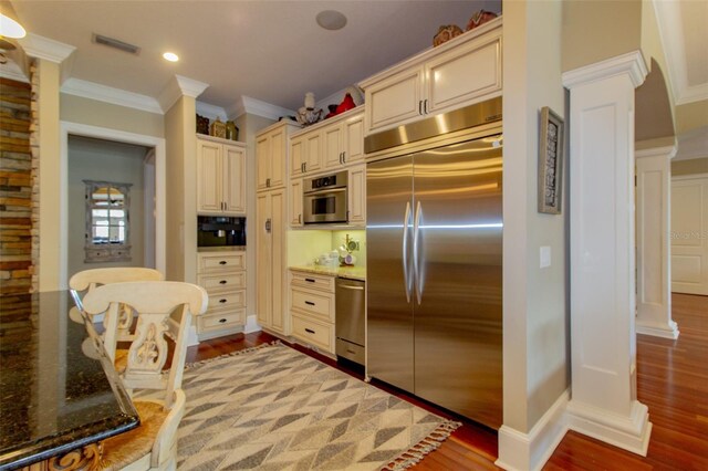 kitchen featuring light hardwood / wood-style flooring, cream cabinetry, and appliances with stainless steel finishes