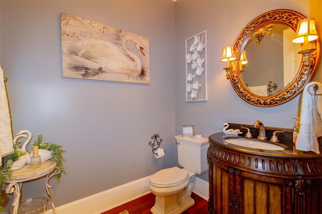 bathroom featuring wood-type flooring, vanity, and toilet